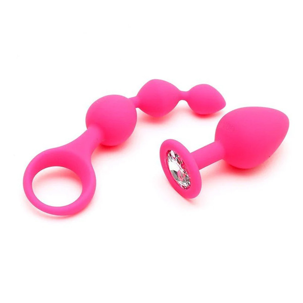 Två rosa sexleksaker i silikon, en med en ring och kulor, den andra med en dekorativ kristall i botten. Sinamatic